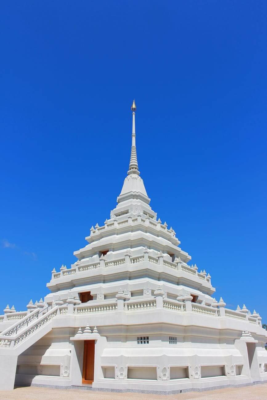 white concrete temple under the blue sky